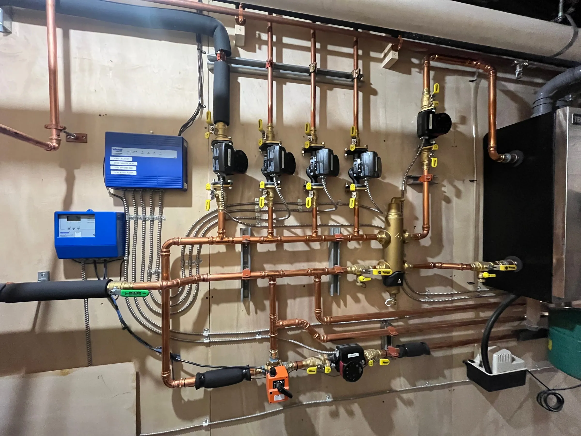 Boiler and radiant heat piping installation in a residential mechanical room