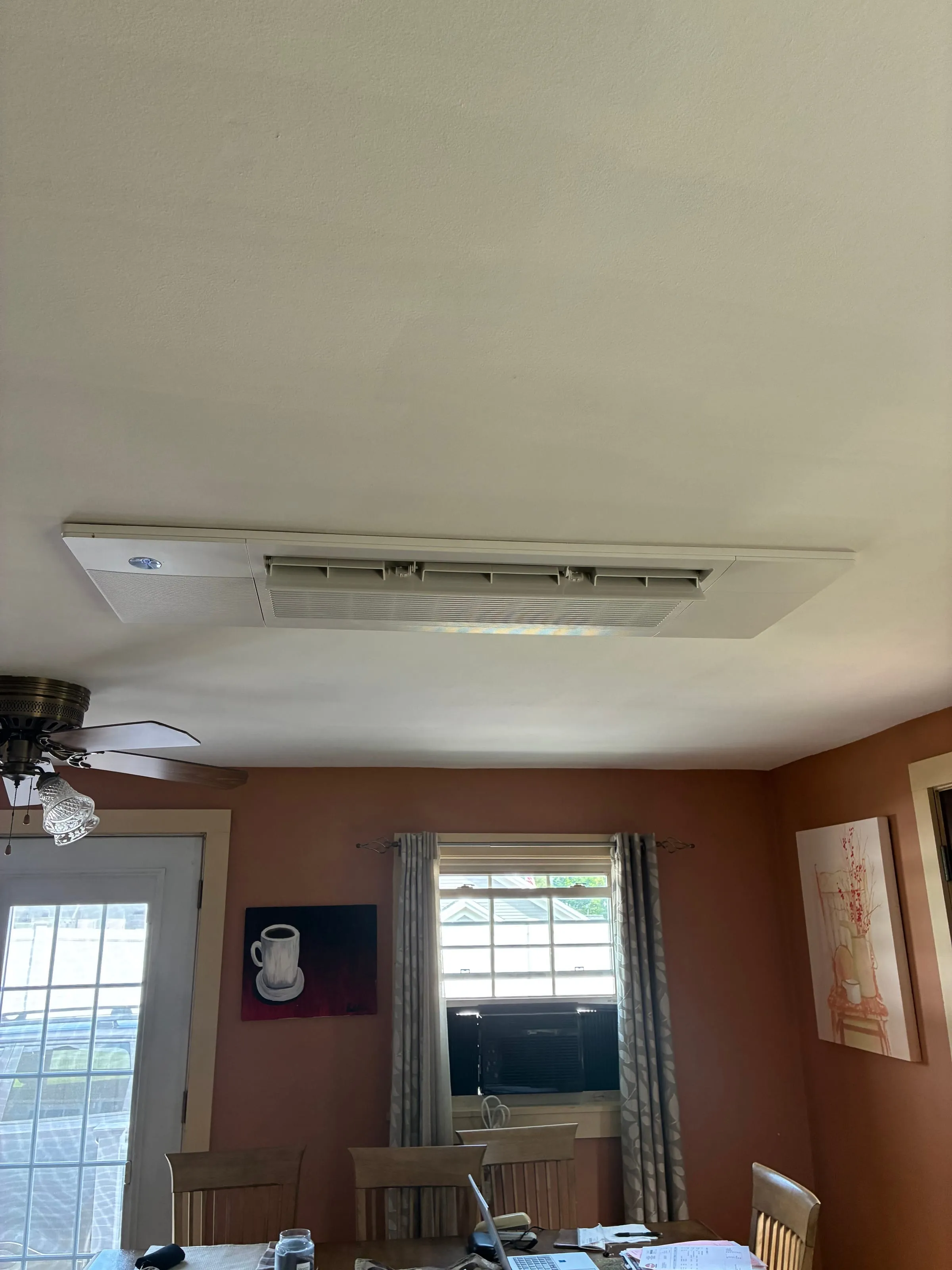 Ceiling cassette heat pump installed flush in a dining room ceiling